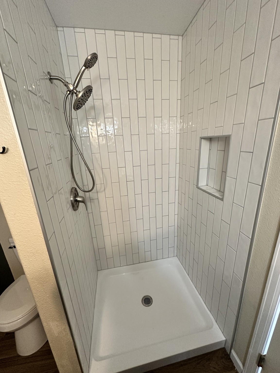 Completed tiled shower with niche