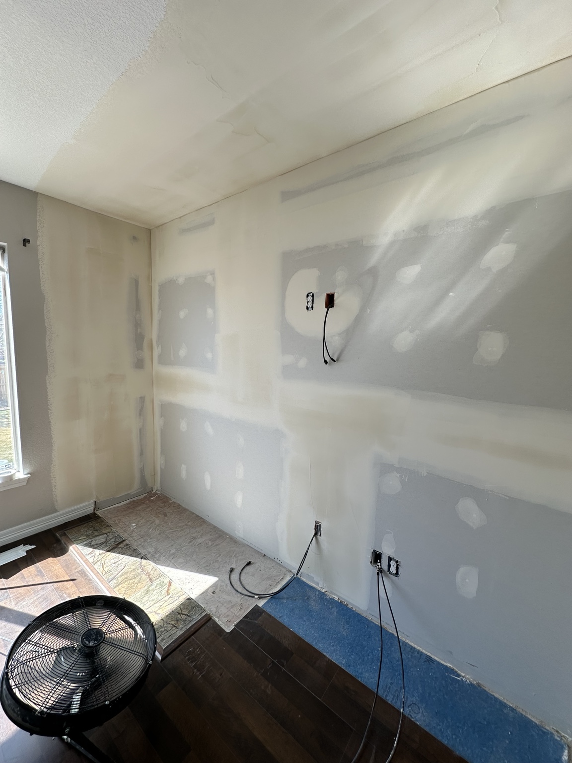 Drywall repair and wall restoration in progress